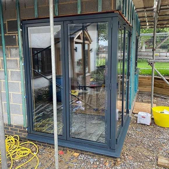 Floating corner post in a set of Origin bi-folding doors with integral blinds in Anthracite Grey - Oxfordshire