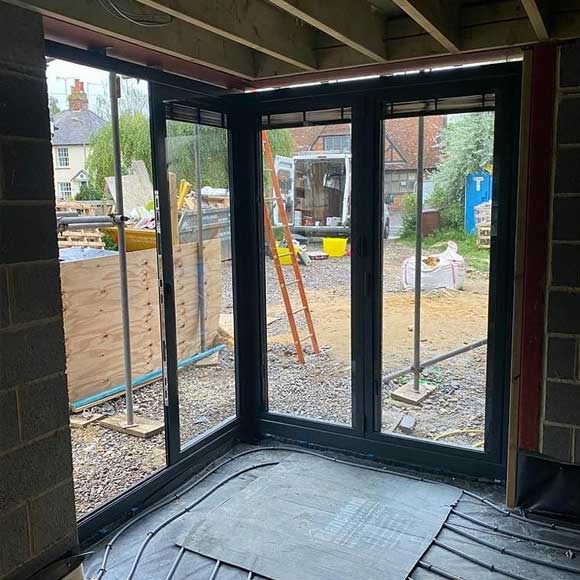 Floating corner post in a set of Origin bi-folding doors with integral blinds in Anthracite Grey - Oxfordshire