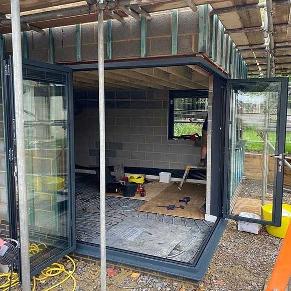 Floating corner post in a set of Origin bi-folding doors with integral blinds in Anthracite Grey - Oxfordshire